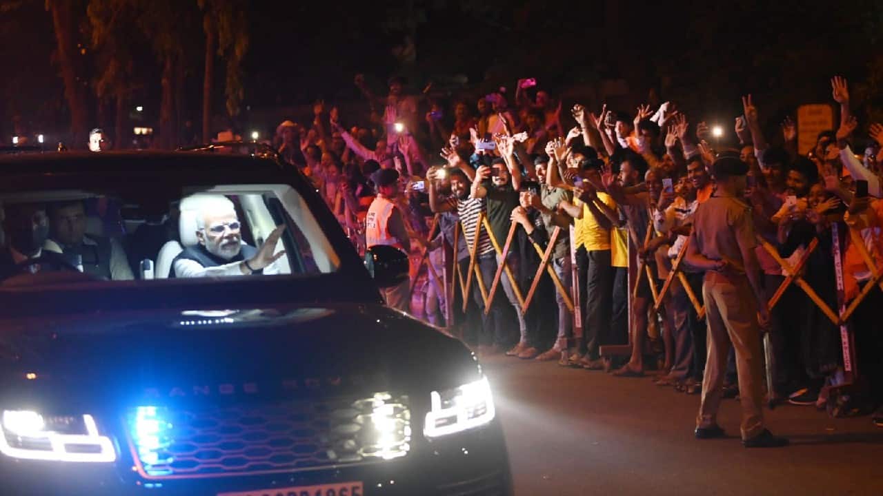 Thousands of people gathered on both sides of the road along the 27-km route of the roadshow from the Surat airport to Varaccha, the city’s principal hub for diamond cutting and polishing. (Image: Twitter @narendramodi)