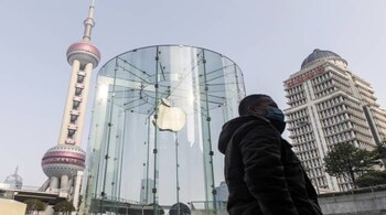 A pedestrian walks past a closed Apple Inc. store in Shanghai, China. - Bloomberg