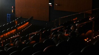 Customers watch a film at a movie theater in Rio de Janeiro, Brazil, on Saturday, Sept. 18, 2021. Rio de Janeiro is requiring proof of vaccination in order to enter public events, touristic points, movie theaters, sports stadiums, and other entertainment activities, as the country sees more than 21 million Covid-19 cases. Photographer: Andre Borges/Bloomberg