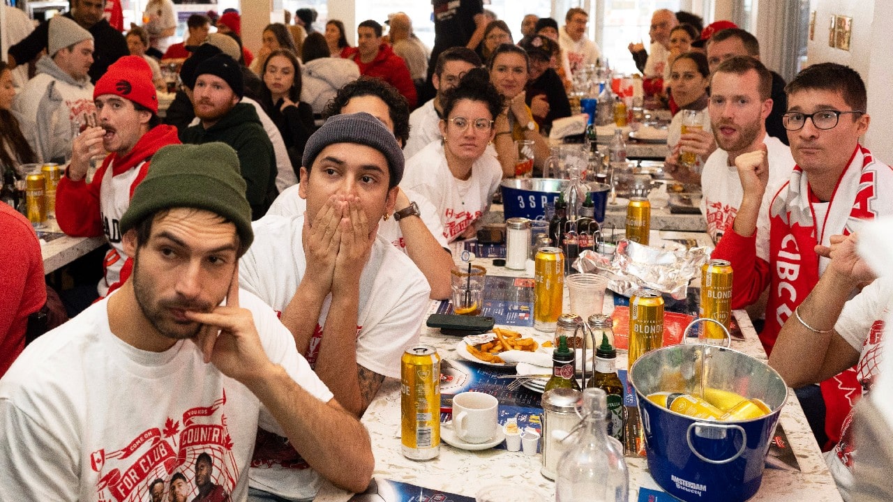 Fans react to Croatia scoring a goal as they cheer on Canada in their match against Croatia at the FIFA World Cup in Toronto on November 27. Canada lost the match 4 to 1. Canadian soccer fans are now mulling which teams to root for next after Canada was eliminated from the World Cup following their loss against Croatia. (Image: AP)