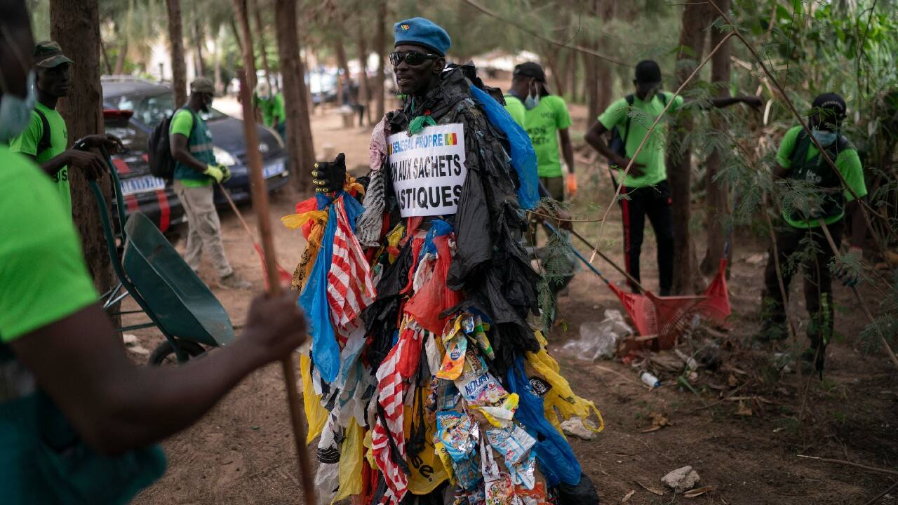 Environmental activist Modou Fall, who many simply call “Plastic Man,” wears his uniform — “it's not a costume,” he emphasizes — while telling anybody who will listen about the problems of plastics. As he walks, strands and chunks of plastic dangle from his arms and legs, rustling in the wind while some drags on the ground. On Fall's chest, poking out from the plastics, is a sign in French that says, “No to plastic bags.” (Image: AP)