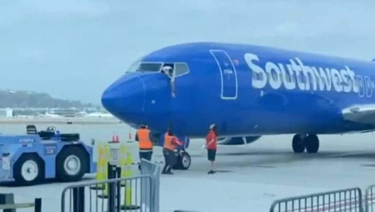 Watch: Pilot hangs out of cockpit window to retrieve flyer's phone