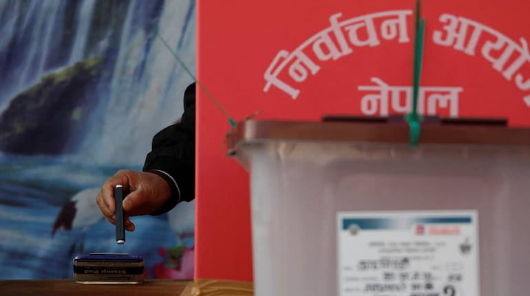 A man casts his vote during the general election, in Kathmandu, Nepal on November 20, 2022. (Image: REUTERS)