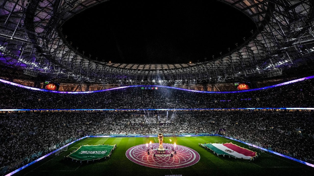 A huge word cup trophy is illuminated by fire in the center of the pitch before the World Cup group C soccer match between Saudi Arabia and Mexico, at the Lusail Stadium in Lusail, Qatar. (Source: AP)