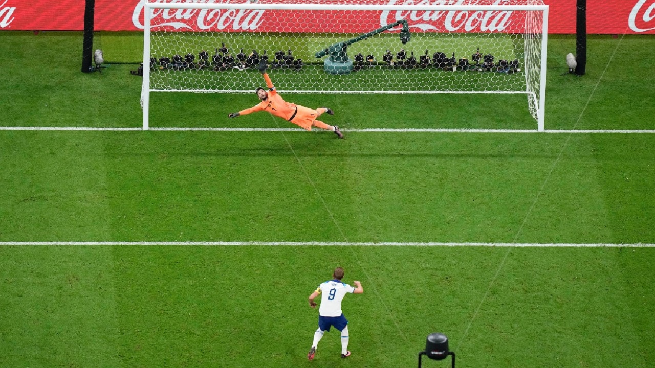 England's Harry Kane misses a penalty shot sending the ball over the bar as France's goalkeeper Hugo Lloris dives during the World Cup quarterfinal soccer match between England and France, at the Al Bayt Stadium in Al Khor, Qatar. (Image: AP) England's Harry Kane misses a penalty shot sending the ball over the bar as France's goalkeeper Hugo Lloris dives during the World Cup quarterfinal soccer match between England and France, at the Al Bayt Stadium in Al Khor, Qatar. (Image: AP)