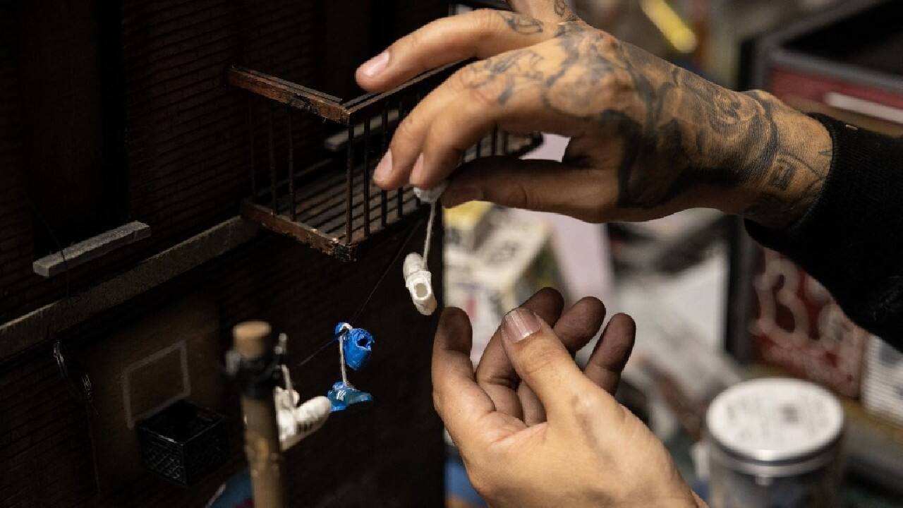With his nimble fingers and child-like enthusiasm, Danny Cortes re-creates in miniature the hip-hop-infused street scenes of a gritty New York. But what began as a hobby has since brought him fame in the rap community and profitable sales even at Sotheby's prestigious auction house. &quot;We are adults, but we never stopped being kids,&quot; the 42-year-old artist tells AFP. &quot;Who doesn't like toys? Who doesn't like miniatures?&quot; As he spoke from his workshop in the Bushwick neighborhood of Brooklyn, he sat among recycled objects found on the streets. (Image: AFP)