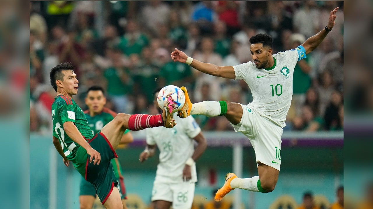 Mexico's Hirving Lozano and Saudi Arabia's Salem Al-Dawsari kick the ball during the World Cup group C soccer match between Saudi Arabia and Mexico, at the Lusail Stadium in Lusail, Qatar. (Source: AP)