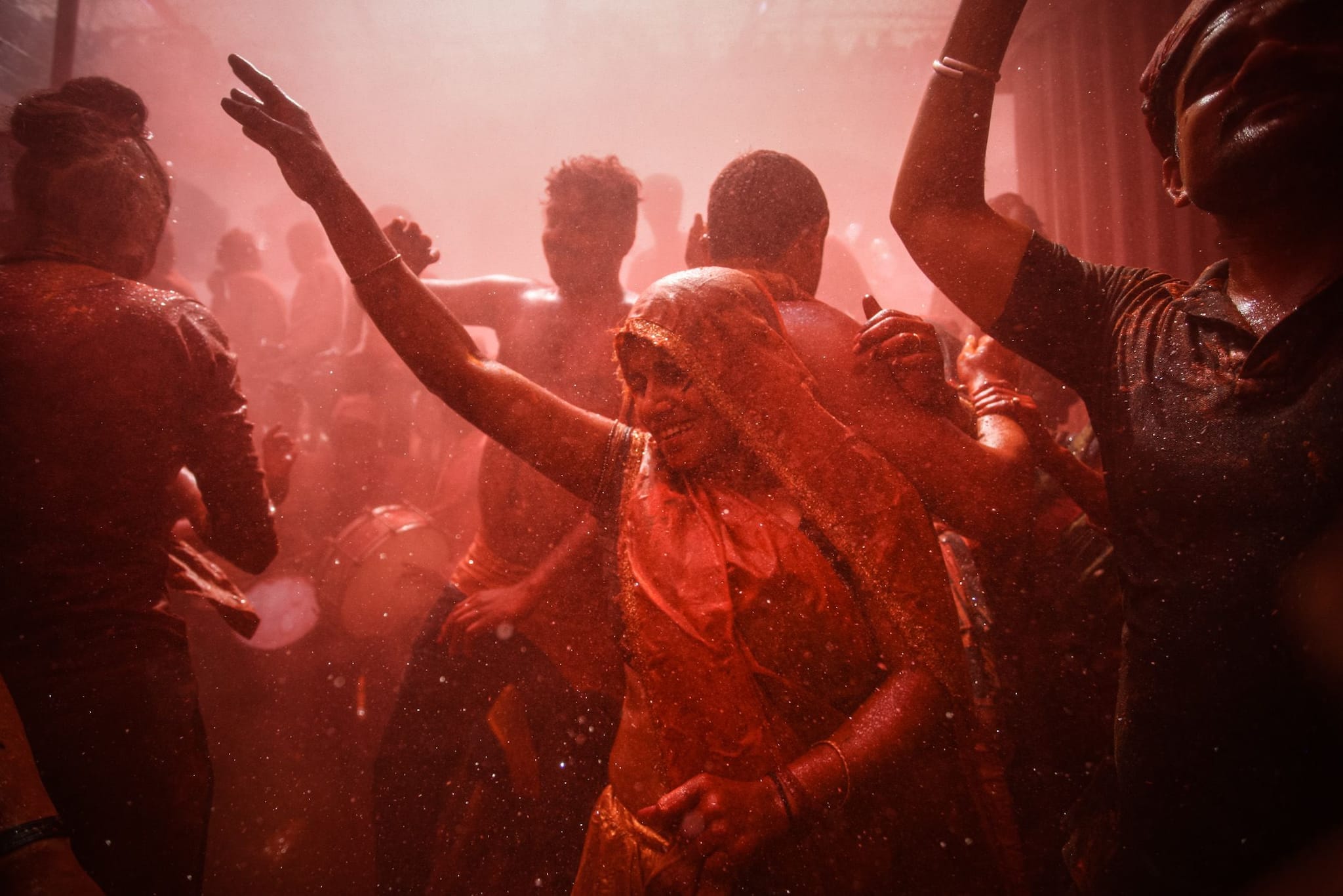 Hindu devotees dance during Huranga celebrations in a courtyard on March 19 at the Dauji Temple in Mathura. As women playfully try to tear mens shirts off, the crowd gets inundated with colored powders and water. Photographer: Ritesh Shukla/Getty Images AsiaPac