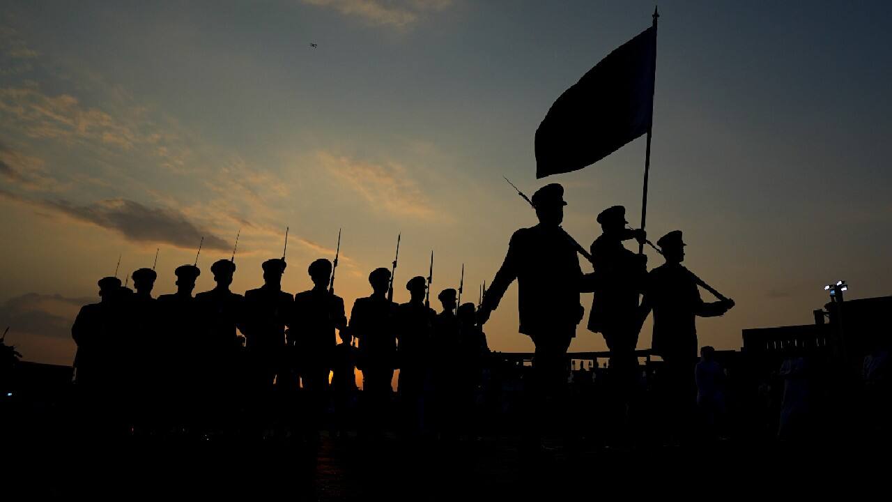 Members of the Qatar Armed Forces Band Regiment march in formation as boats with sails in the national colors of the four remaining World Cup teams hover in the harbor. (Image: AP)