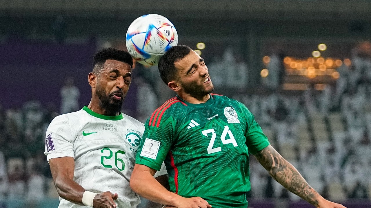 Saudi Arabia's Riyadh Sharahili, left, and Mexico's Luis Chavez head the ball during the World Cup group C soccer match between Saudi Arabia and Mexico, at the Lusail Stadium in Lusail, Qatar. (Source: AP)