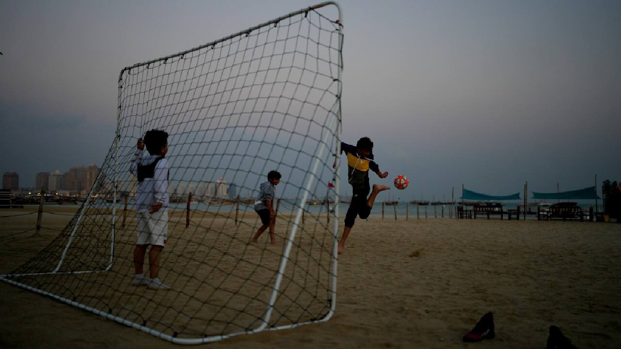 At Katara beach in Doha, children play soccer on the golden sand during the day, while others go for a swim at night in waters lit by the capital's glimmering skyline. (Image: AP)