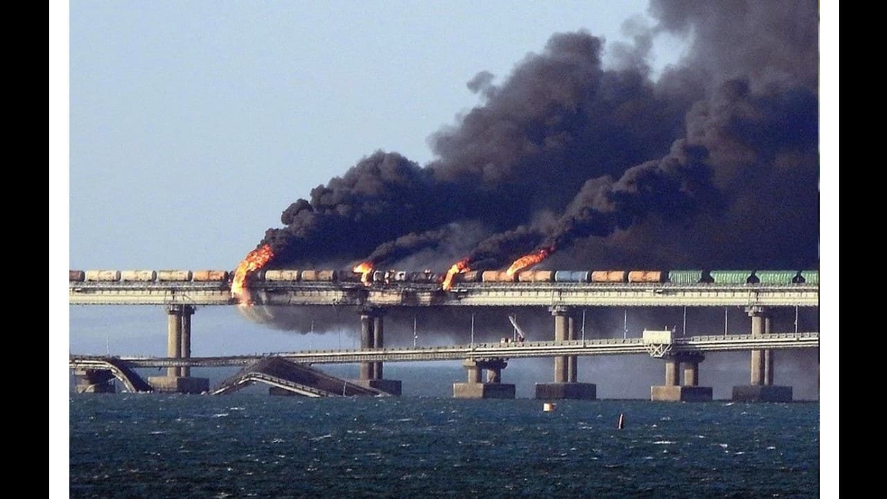 Black smoke billows from a fire on the Kerch bridge that links Crimea to Russia, after a truck reportedly exploded, near Kerch, on October 8. (Image: AFP)