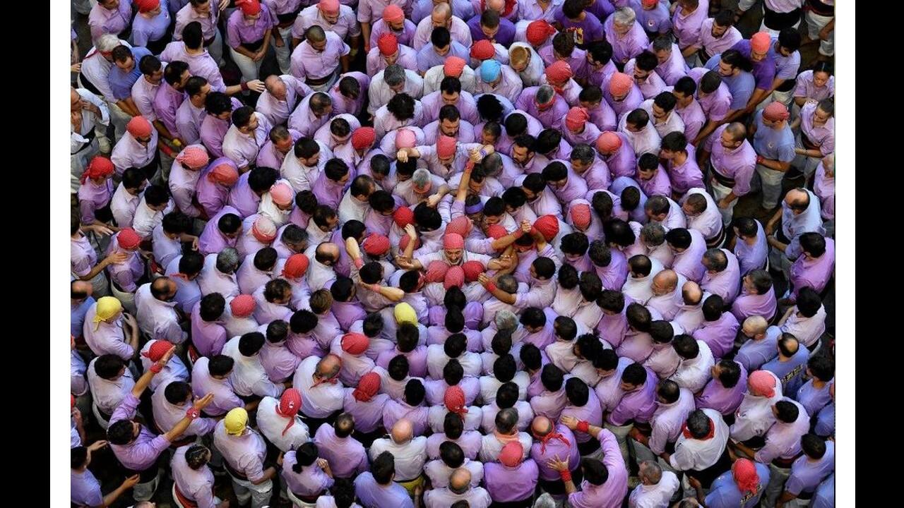 Members of the &quot;Jove de Tarragona&quot; team attempt to form a &quot;castell&quot; (human tower) during the 28th edition of the 'castells' competition at the Tarraco arena in Tarragona on October 2. (Image: AFP)
