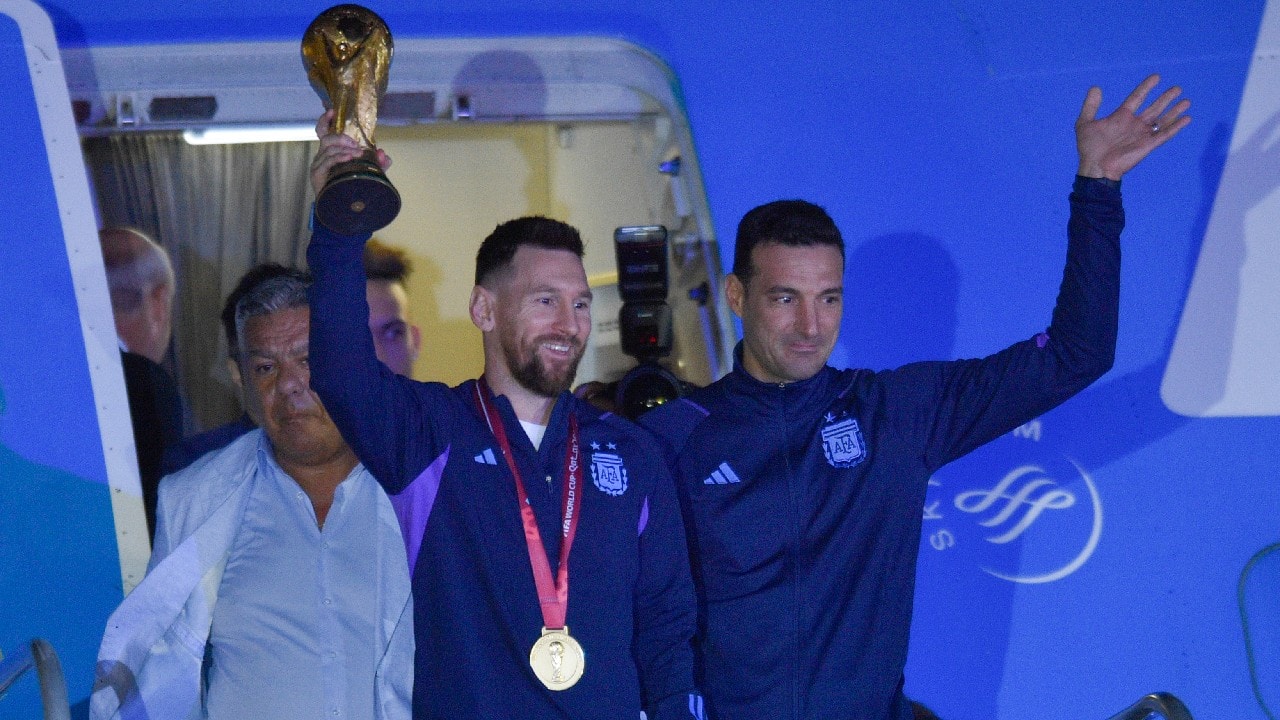 Messi was the first player from the plane carrying the World Cup, flanked by coach Lionel Scaloni, who put his arm around the captain as they walked past a sign that read, “Thank you, champions.” (Image: AP)
