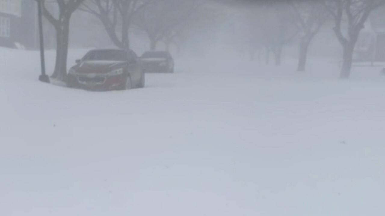 Ditjak Ilunga of Gaithersburg, Maryland, was on his way to visit relatives in Hamilton, Ontario, for Christmas with his daughters on December 23 when their SUV was trapped in Buffalo. Unable to get help, they spent hours with the engine running, buffeted by wind and nearly buried in snow. (Image: AP)
