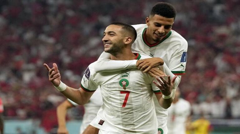 Morocco's Hakim Ziyech, foreground, celebrates after scoring his side's opening goal besides team mate Azzedine Ounahi during the World Cup group F soccer match between Canada and Morocco at the Al Thumama Stadium in Doha , Qatar, Thursday, Dec. 1, 2022. (AP Photo/Pavel Golovkin)