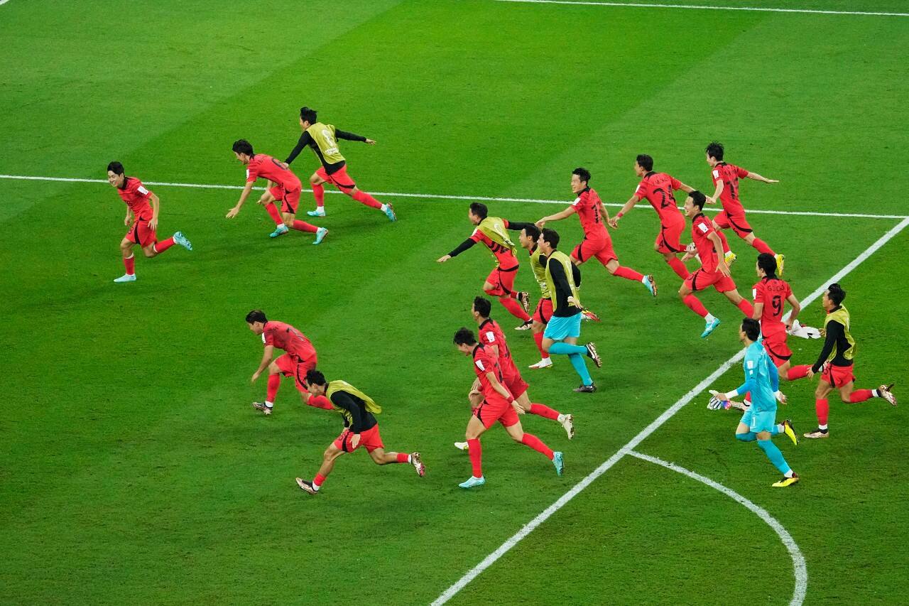 South Korea's team players celebrate after the World Cup group H soccer match between South Korea and Portugal, at the Education City Stadium in Al Rayyan, Qatar, Friday, Dec. 2, 2022. (AP Photo/Darko Bandic)