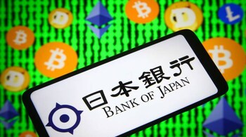 Bank of Japan logo on a smartphone screen and Bitcoin, Ethereum, Litecoin and Dogecoin cryptocurrencies logos in the background. (Photo Illustration via Getty Images)