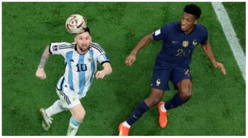 Argentina's Lionel Messi (L) eyes the ball as he is marked by France's forward Kingsley Coman (R) during the Qatar 2022 World Cup final football match.