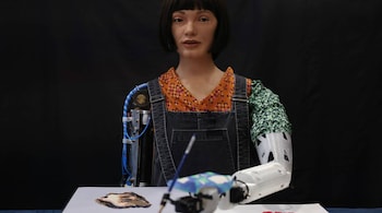 Ai-Da Robot, an ultra-realistic humanoid robot artist, paints during a press call at The British Library on April 4, 2022 in London, England. (Photo by Hollie Adams/Getty Images)