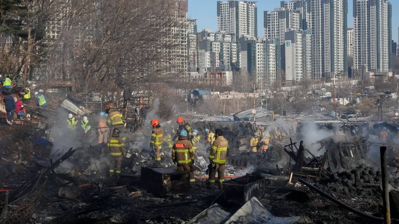 Shin Yong-ho, an official at the fire department of Seoul’s Gangnam district, said rescue workers were continuing to search areas affected by the fire but that it was believed that all residents have safely evacuated. More than 800 firefighters, police officers and public workers fought the flames and handled evacuations after the fire began around 6:30 a.m. Photos showed firefighters fighting the flames under thick, white smoke covering the village as helicopters sprayed water from above. Later orange-suited rescuers searched through the charred landscape where gray tendrils of smoke were still rising. The capital's skyscrapers gleamed a short distance away. (Image: AP)