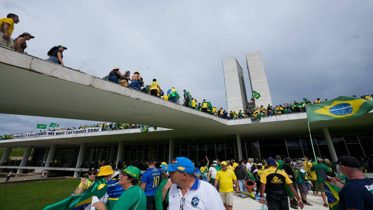 Protesters, supporters of Brazil's former President Jair Bolsonaro, storm the the National Congress building in Brasilia, Brazil. (Image: AP)