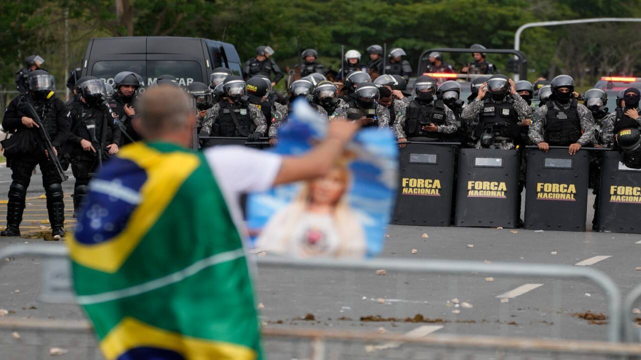 A supporter of Brazil's former President Jair Bolsonaro, in confronted by a police phalanx after the demonstrators stormed the Planalto Palace in Brasilia, Brazil. (Image: AP)