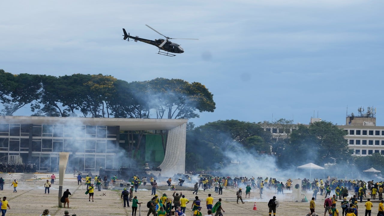 Protesters, supporters of Brazil's former President Jair Bolsonaro, clash with police as they storm the Planalto Palace in Brasilia, Brazil. Planalto is the official workplace of the president of Brazil. (Image: AP)