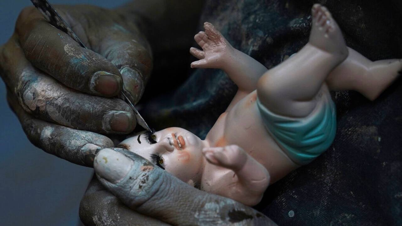 A man repairs a Baby Jesus figure in Mexico City, Wednesday, Jan. 25, 2023. As Mexicans prepare to celebrate &quot;Dia de la Candelaria&quot; or Candlemas. people bring in their Baby Jesus figures for major repairs. 