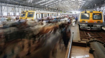 Commuters walk along a railway platform during the morning rush hour in this long exposure photograph taken at Churchgate Station near the financial district of Mumbai, India, on Friday, April 4, 2014. Photographer: Vivek Prakash/Bloomberg
