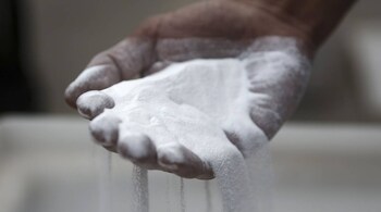 A Ma'aden worker holds a handful of processed alumina inside the aluminium plant at the Ras Al Khair Industrial City, operated by the Saudi Arabian Mining Co. (Ma'aden), in Ras Al Khair, Saudi Arabia. The site is a multi-commodity minerals industrial city built by Ma’aden and its partners located 90 km north of Jubail in Saudi Arabia’s Eastern Province.