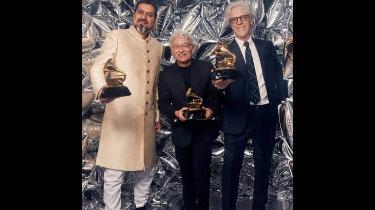 (From left) Ricky Kej, Herbert Waltl, and Stewart Copeland pose in the press room with the award for best immersive audio album for 'Divine Tides' at the 65th annual Grammy Awards on Sunday. (Photo: Jae C Hong/Invision/AP)
