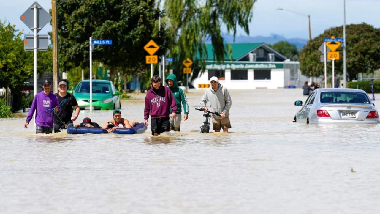 When residents do venture out, they wade through murky floodwaters to get supplies or huddle on the steps of a few buildings that still have wifi, trying to get in touch with loved ones. (Source: AFP) When residents do venture out, they wade through murky floodwaters to get supplies or huddle on the steps of a few buildings that still have wifi, trying to get in touch with loved ones. (Source: AFP)