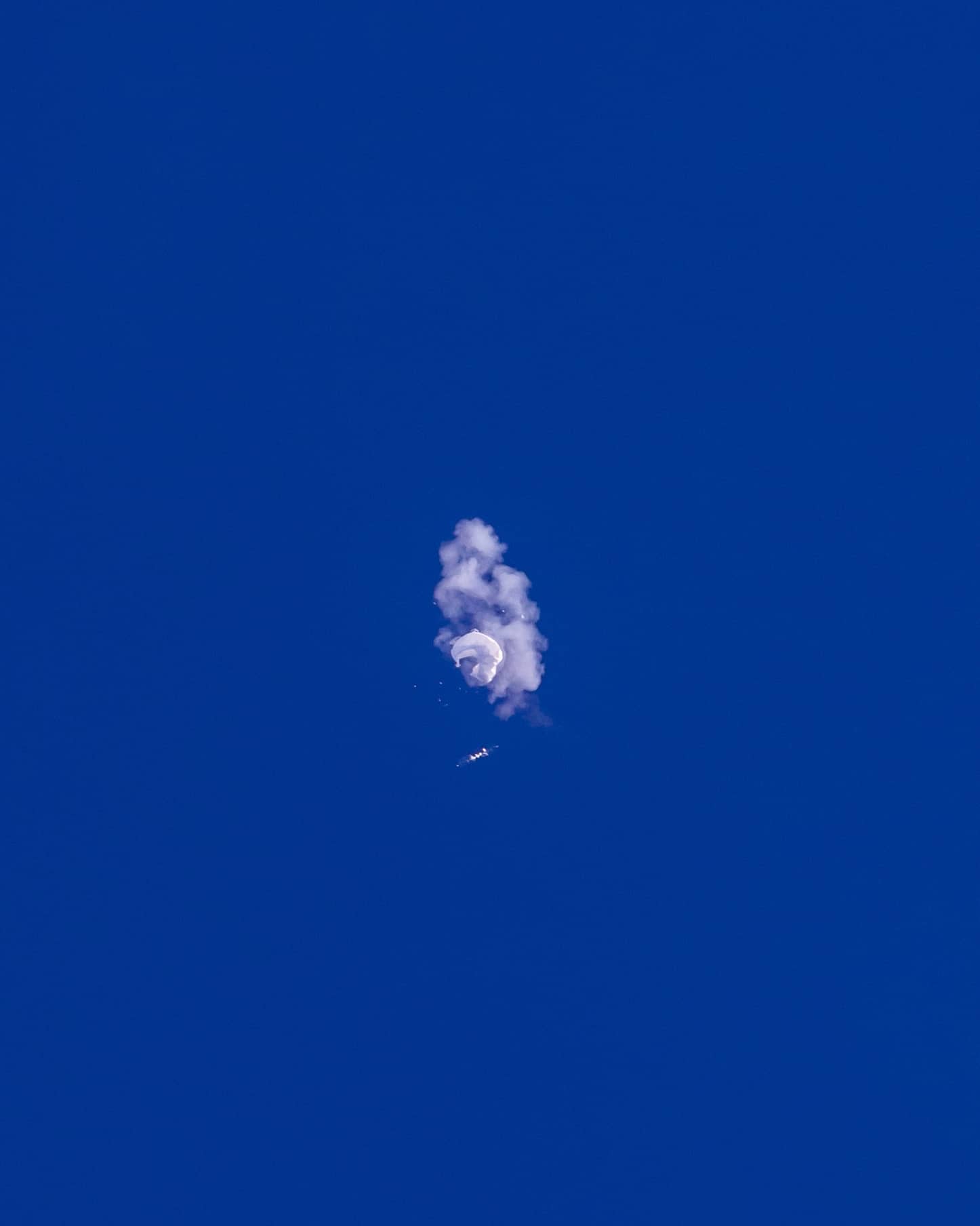 In this photo provided by Chad Fish, a large balloon is struck down above the Atlantic Ocean, just off the coast of South Carolina, Saturday, Feb. 4, 2023. The downing of the suspected Chinese spy balloon by a missile from an F-22 fighter jet created a spectacle over one of the state’s tourism hubs and drew crowds reacting with a mixture of bewildered gazing, distress and cheering. (Chad Fish via AP) In this photo provided by Chad Fish, a large balloon is struck down above the Atlantic Ocean, just off the coast of South Carolina, Saturday, Feb. 4, 2023. The downing of the suspected Chinese spy balloon by a missile from an F-22 fighter jet created a spectacle over one of the state’s tourism hubs and drew crowds reacting with a mixture of bewildered gazing, distress and cheering. (Chad Fish via AP)
