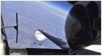 The photo shows the top of the pilot's helmet inside the U-2 cockpit with the suspected Chinese spy balloon flying below. (Image source: AFP)