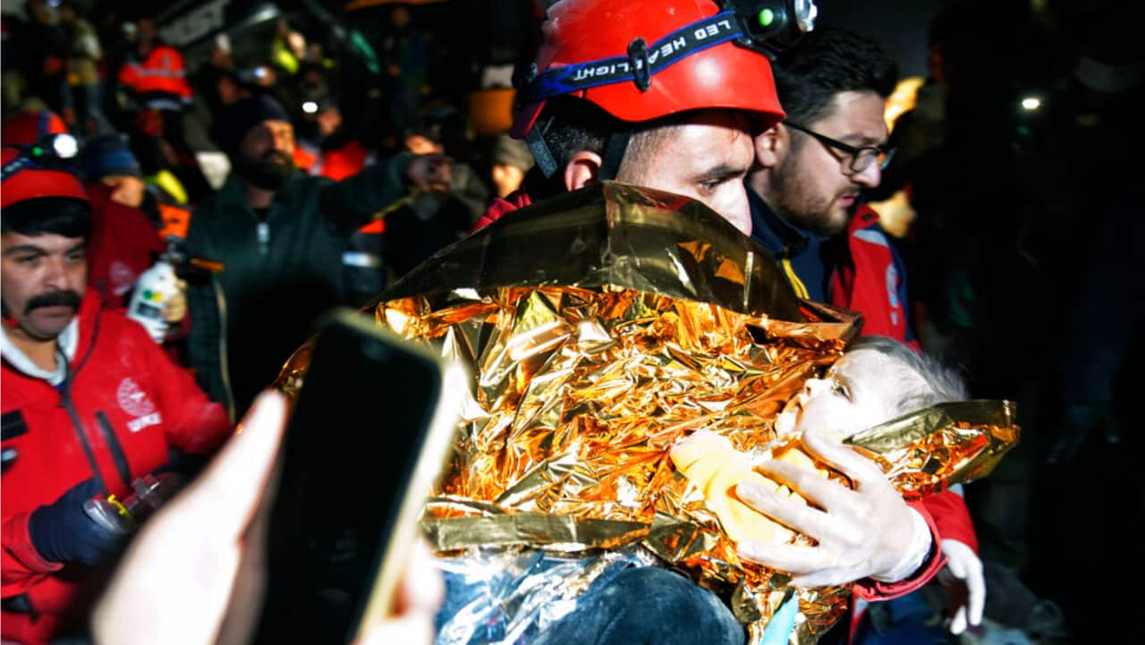 A rescuer holds baby Belen, pulled out from a collapsed building 2 days after the earthquake, in Hatay southern Turkey.