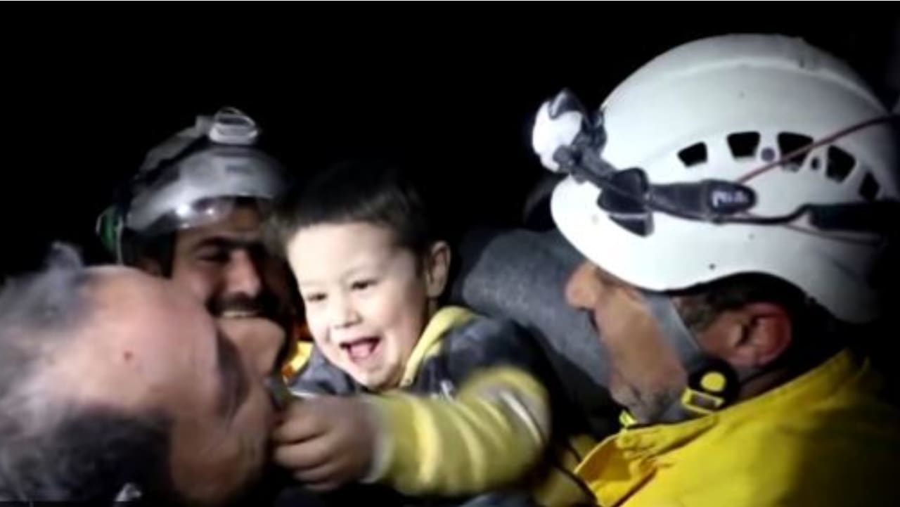 Watch: Syrian boy smiles, plays with rescue workers who pulled him out of rubble