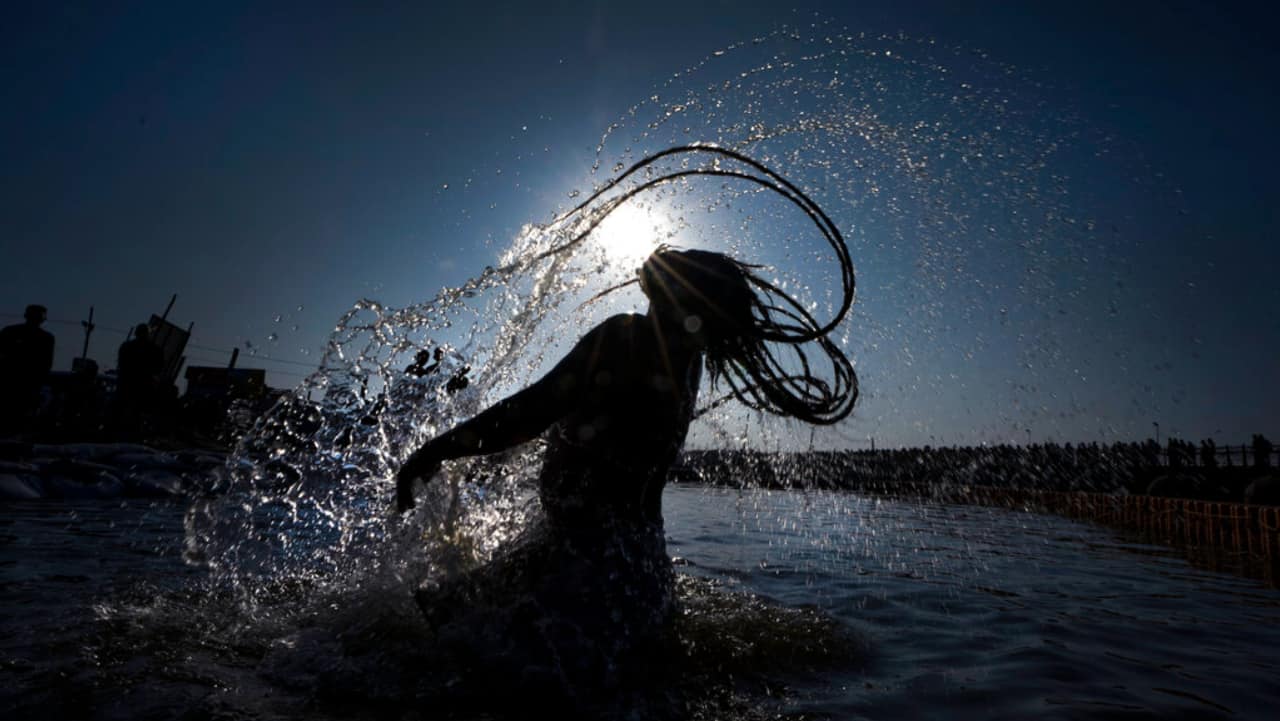 A man take dips at Sangam, the confluence of rivers the Ganges and the Yamuna during &quot;Maghi Purnima&quot;, or the full-moon day of the Hindu calendar month &quot;Magh&quot; in Prayagraj, Uttar Pradesh.
