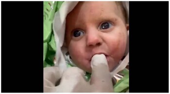 The two-month-old baby was rescued after 128 hours under the rubble in Turkey. (Image: Screengrab from video @partizanGreece1/Twitter)