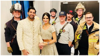 The newlyweds posed with the firefighters after they were rescued. (Image: CharlotteFireDept/Facebook)
