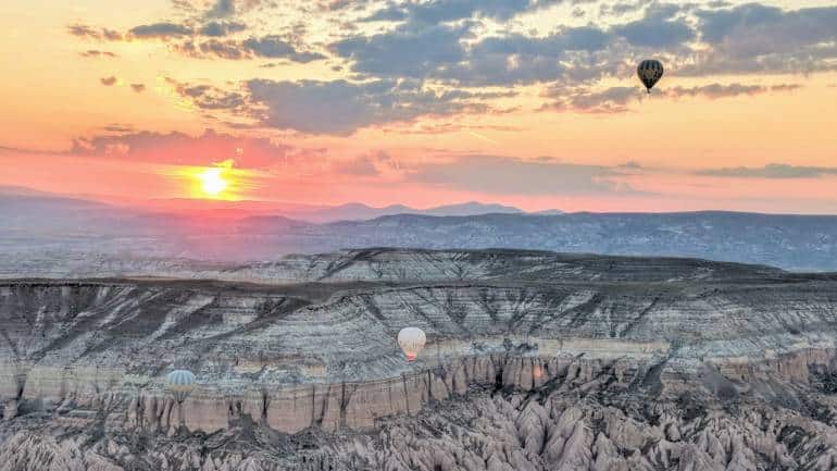 Hot air balloons rise into the skies at dawn, giving travellers a bird’s eye view of the moonlike landscape.