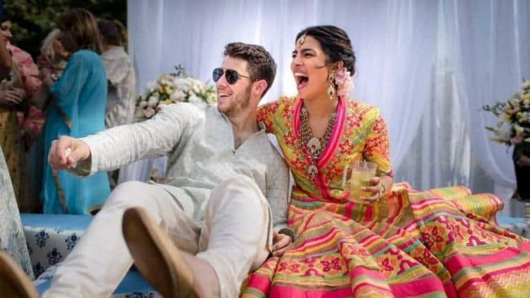 Priyanka Chopra and Nick Jonas in Abu Jani Sandeep Khosla creations and jewellery designed by AJSK crafted by SABOO.
