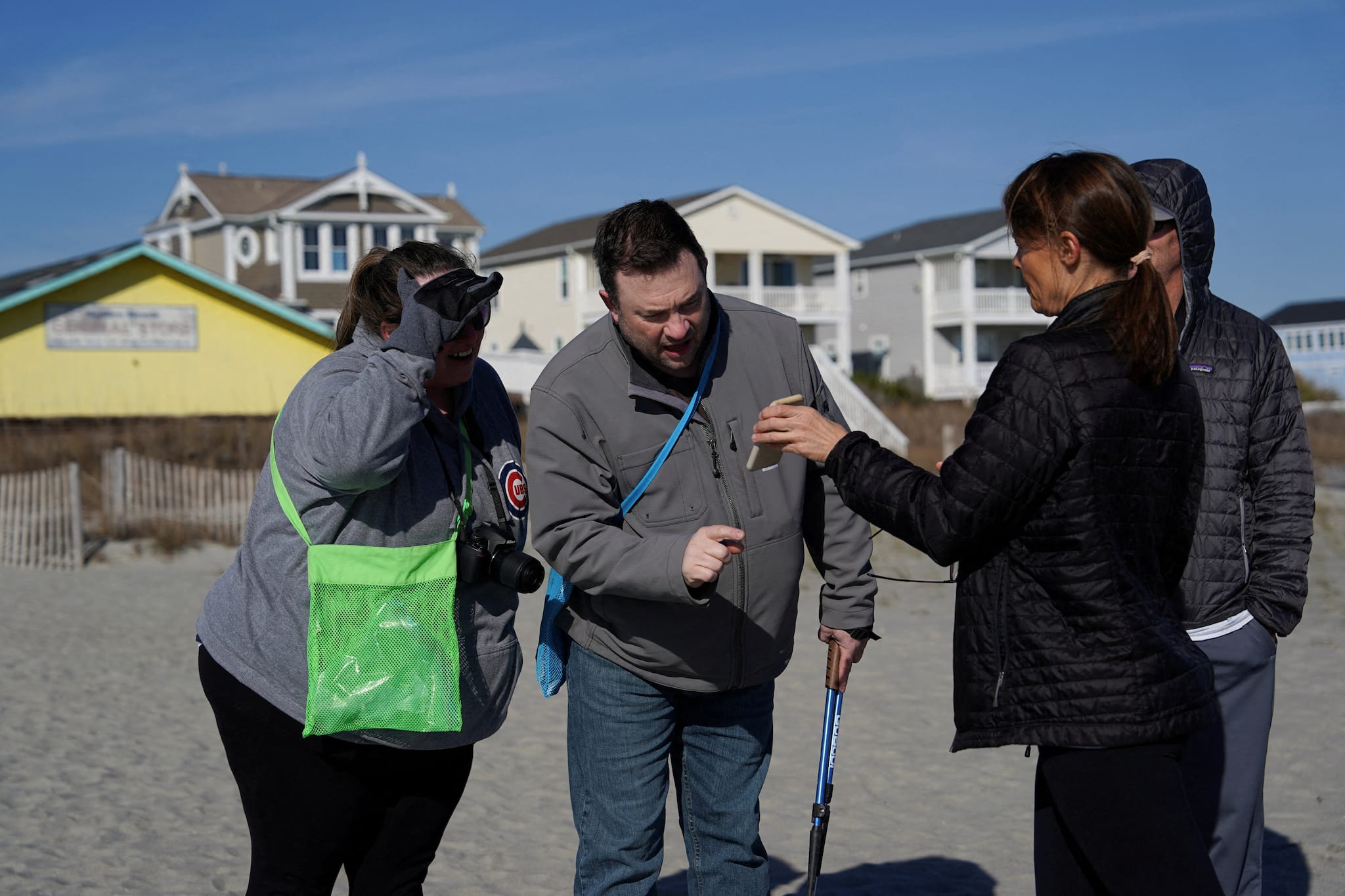 Spectators look at a photo of a suspected Chinese spy balloon after it was shot down off the coast in Holden Beach, North Carolina, U.S. February 4, 2023. (REUTERS/Allison Joyce) Spectators look at a photo of a suspected Chinese spy balloon after it was shot down off the coast in Holden Beach, North Carolina, U.S. February 4, 2023. (REUTERS/Allison Joyce)