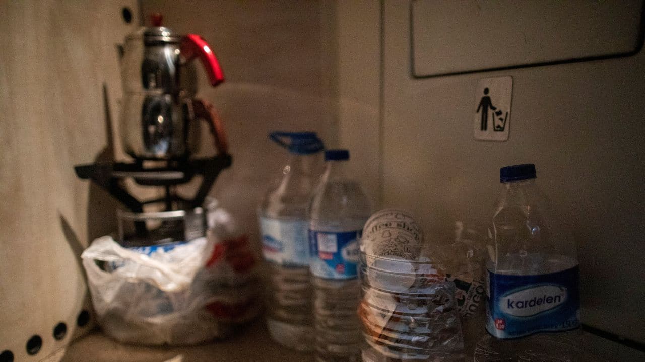 A teapot is heated on a portable gas stove inside the train carriage of Sabriye and Nehir Karan at Iskenderun train station, where train carriages have been turned into temporary shelters for victims of the recent deadly earthquake, in Iskenderun, Turkey, February 23. (Source: Reuters)