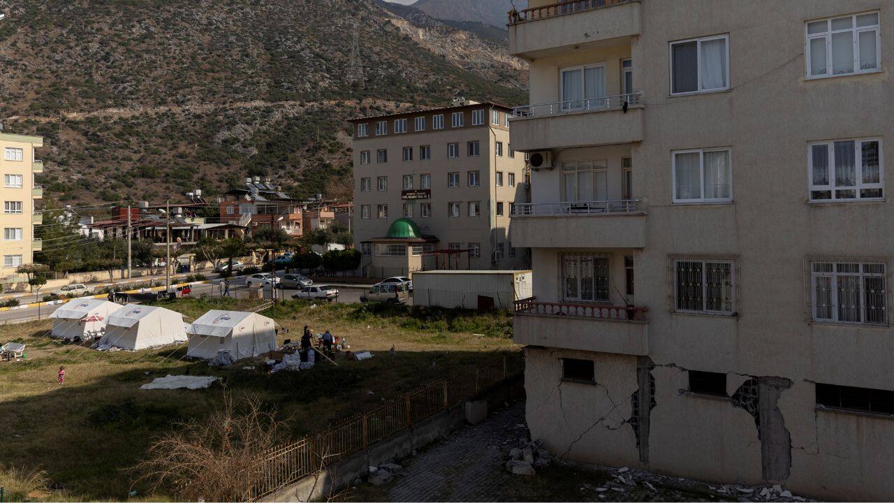 Damaged buildings and local people living in tents are seen from the balcony of Sabriye and Nehir Karan's home, following the deadly earthquake in Iskenderun, Turkey, February 23. The mother and daughter visit their apartment for a couple of hours every other day. They move through it with caution but shower, do the laundry and take some food. When they leave, Sabriye recites a prayer. &quot;I don't know if when I come back, it will still be standing or not,&quot; she said. (Source: Reuters)