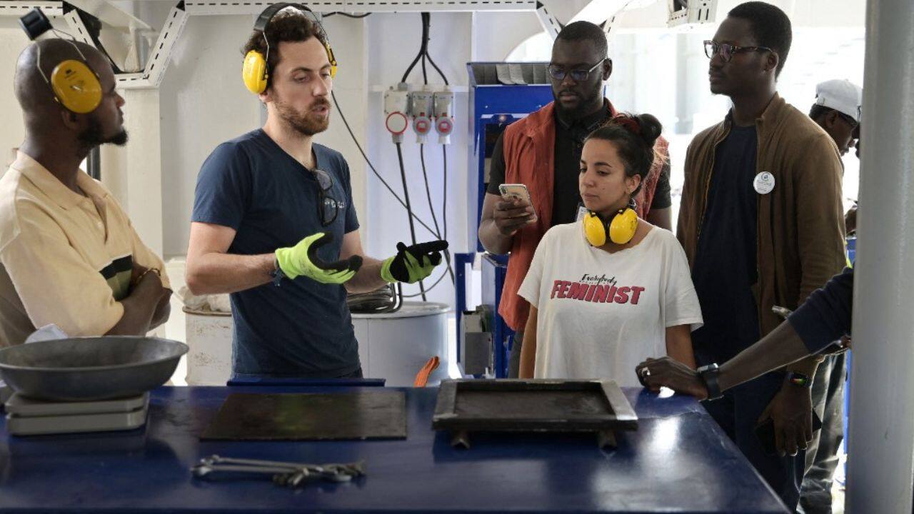 Onboard a ship that recently docked at Dakar, Baptiste Lomenech walked a group of entrepreneurs through some basics in plastic recycling. He's a crewmember with Plastic Odyssey, a three-year around-the-world floating initiative that showcases expertise and equipment to would-be recyclers living in countries struggling with major plastic pollution. (Source: AFP)