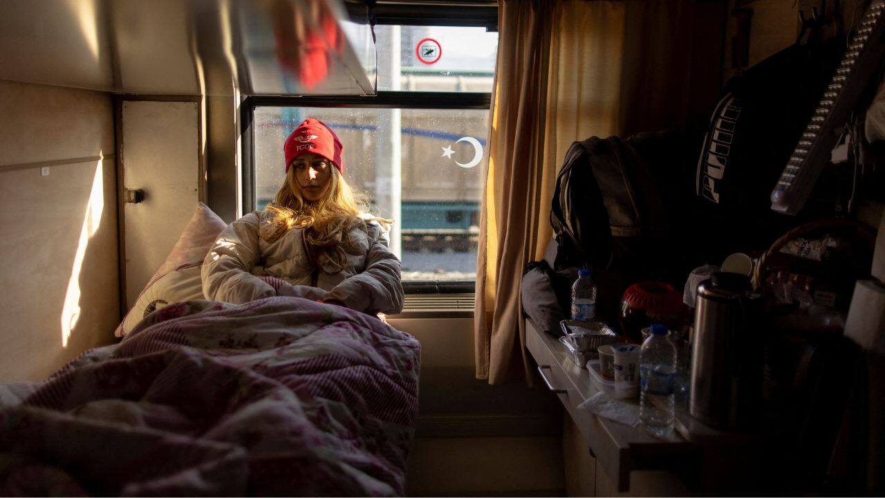 Buce Cermi, 20, the daughter of a train driver, sits in one of the trains at Iskenderun station, where carriages have been turned into temporary shelters for victims of the recent deadly earthquake, in Iskenderun, Turkey, February 15. (Source: Reuters)