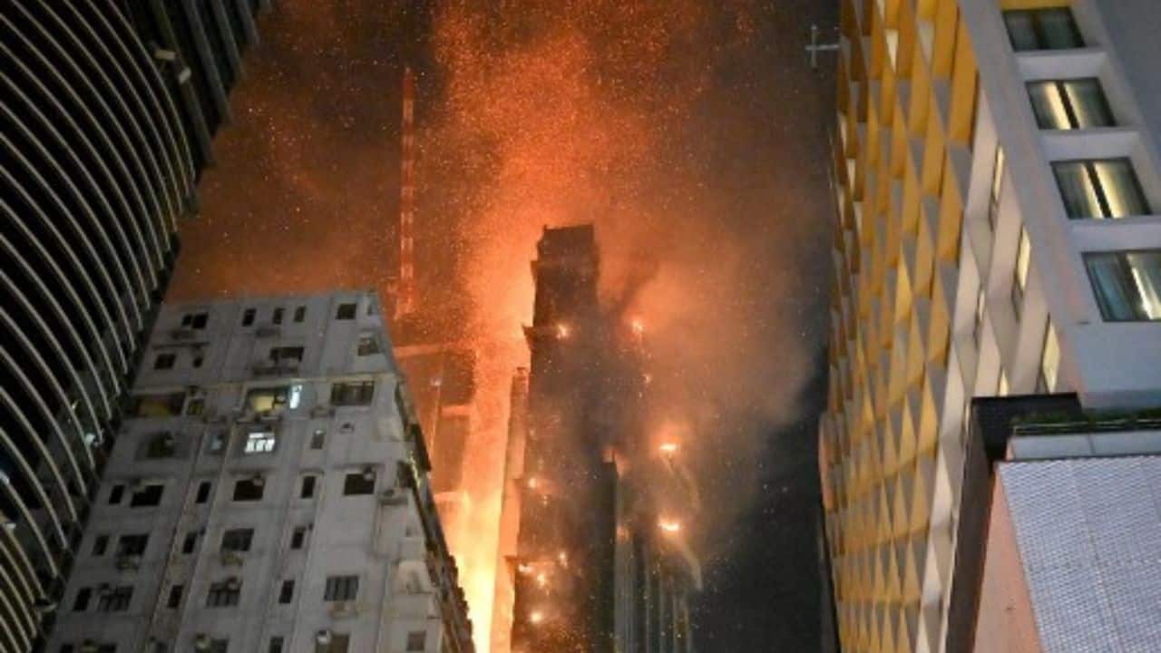 A skyscraper under construction in the heart of a historic Hong Kong shopping and tourist district was left scorched on March 3 by a massive fire, with authorities saying the blaze had been largely extinguished. An AFP journalist at the scene saw blackened concrete walls and the tattered remains of bamboo-and-tarpaulin scaffolding around the building on March 3 morning, as municipal workers swept roads clean of debris. (Source: AFP)