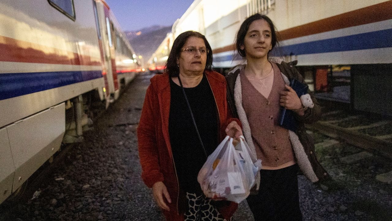Sabriye Karan and her daughter Nehir Karan walk on the tracks at Iskenderun train station, where train carriages have been turned into temporary shelters for victims of the recent deadly earthquake, after receiving food aid in Iskenderun, Turkey, February 17. Their narrow cabin, the width of a train window, holds a few essentials and is warmer in the cold nights than a tent. They spend at least 18 hours a day inside, leaving only to take short walks around the station and line up for breakfast and dinner served by aid groups. (Source: Reuters)