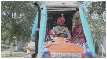 The bride and groom posed on the tractor. (image: @sudhir1544/Twitter)